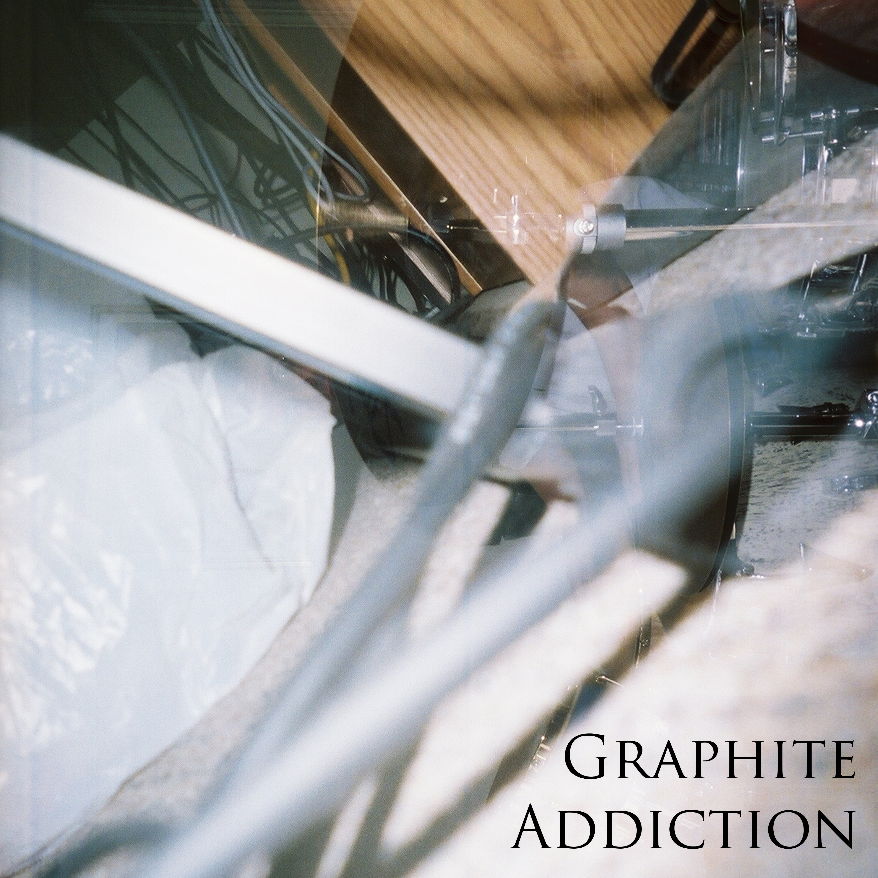 Graphite Addiction album cover. A double exposed photograph. It is difficult to see but seems to be drum stands, a table, and a plastic bag.