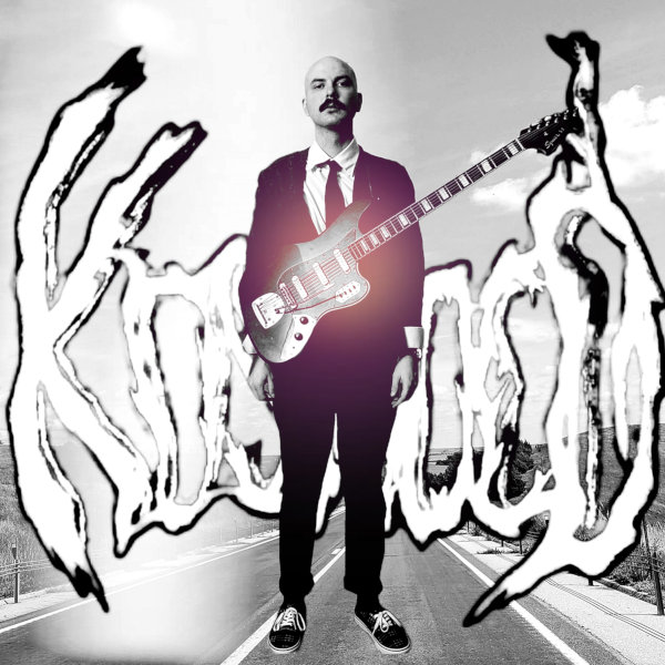 And Let It Swim album cover. A black and white image of Kosnoco in a suit with a Bass VI in front of the Kosnoco Logo